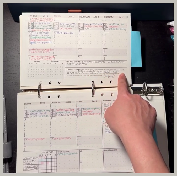 Load video: The video shows a proof copy of a calendar planner being flipped through on a desk, with two hands pointing out various features as they are explained by the voiceover.