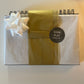 gift wrapped planner in white and gold tissue paper (bow pictured but not included in packages)